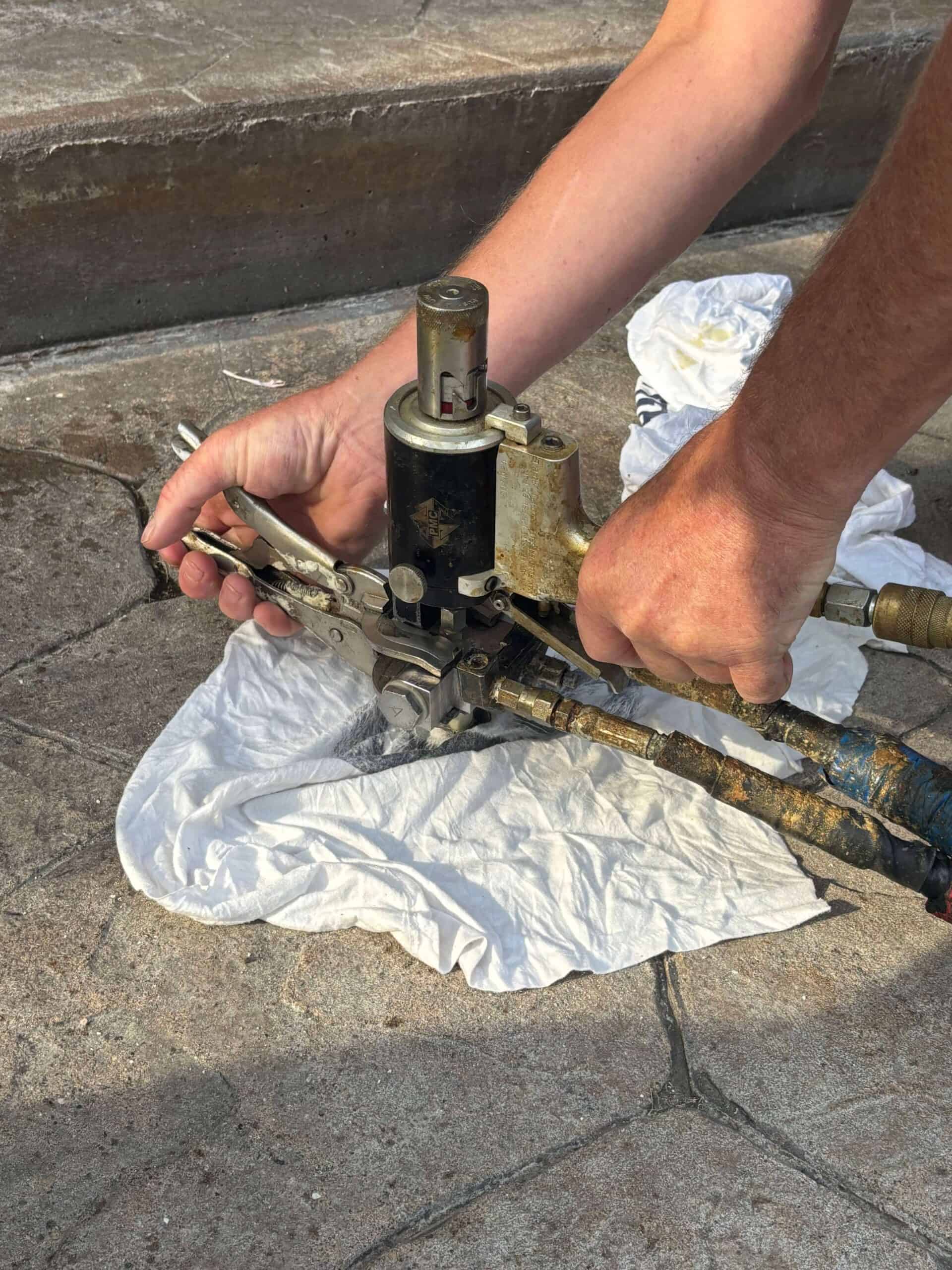 A concrete slab being injected with lifting foam.